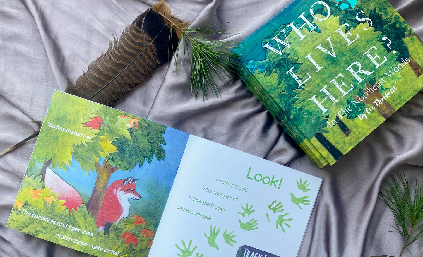 Children's books with nature-themed illustrations on a textured surface.