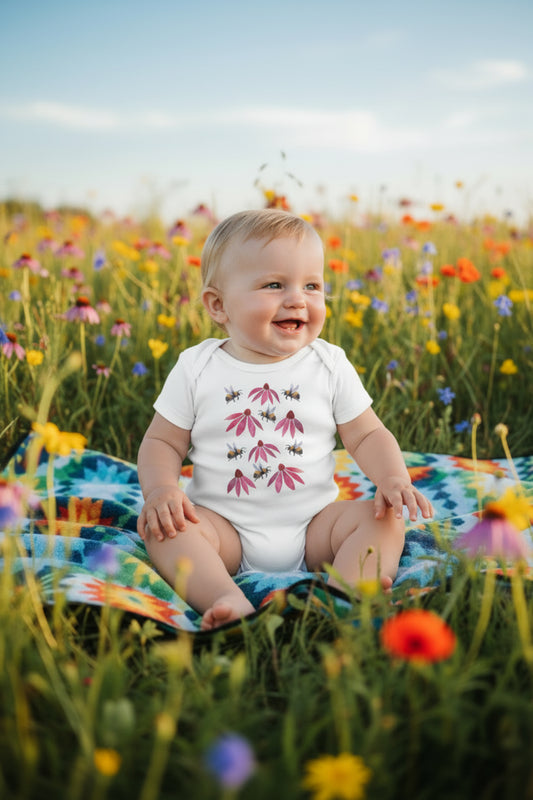 White baby onesie with pink floral and bee design on a white background
